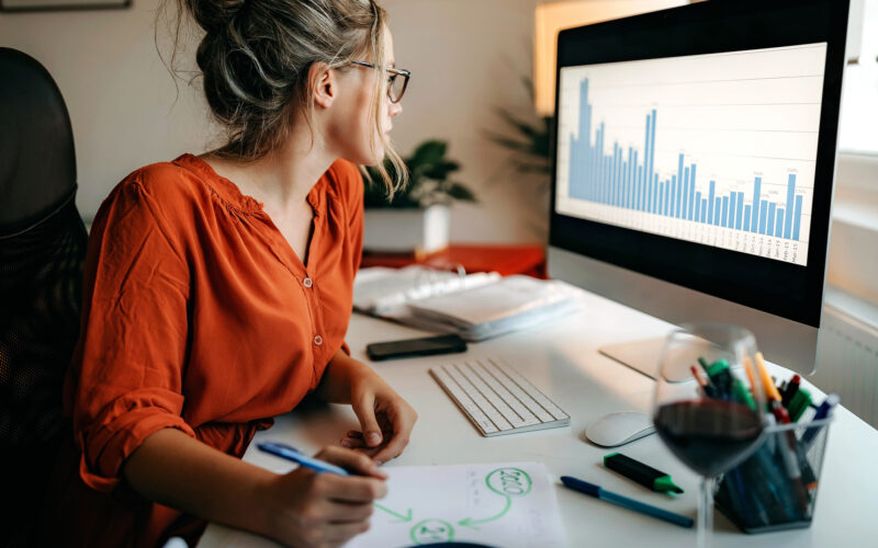 Woman, perhaps practice owner, looking at metrics to improve downtime in her office to make business pick up.
