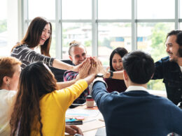 Office staff high fiving.