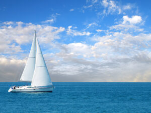 Modern sailboat coasting on calm blue water